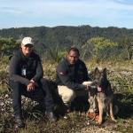 Scott in Papua New Guinea highlands with dog and handler